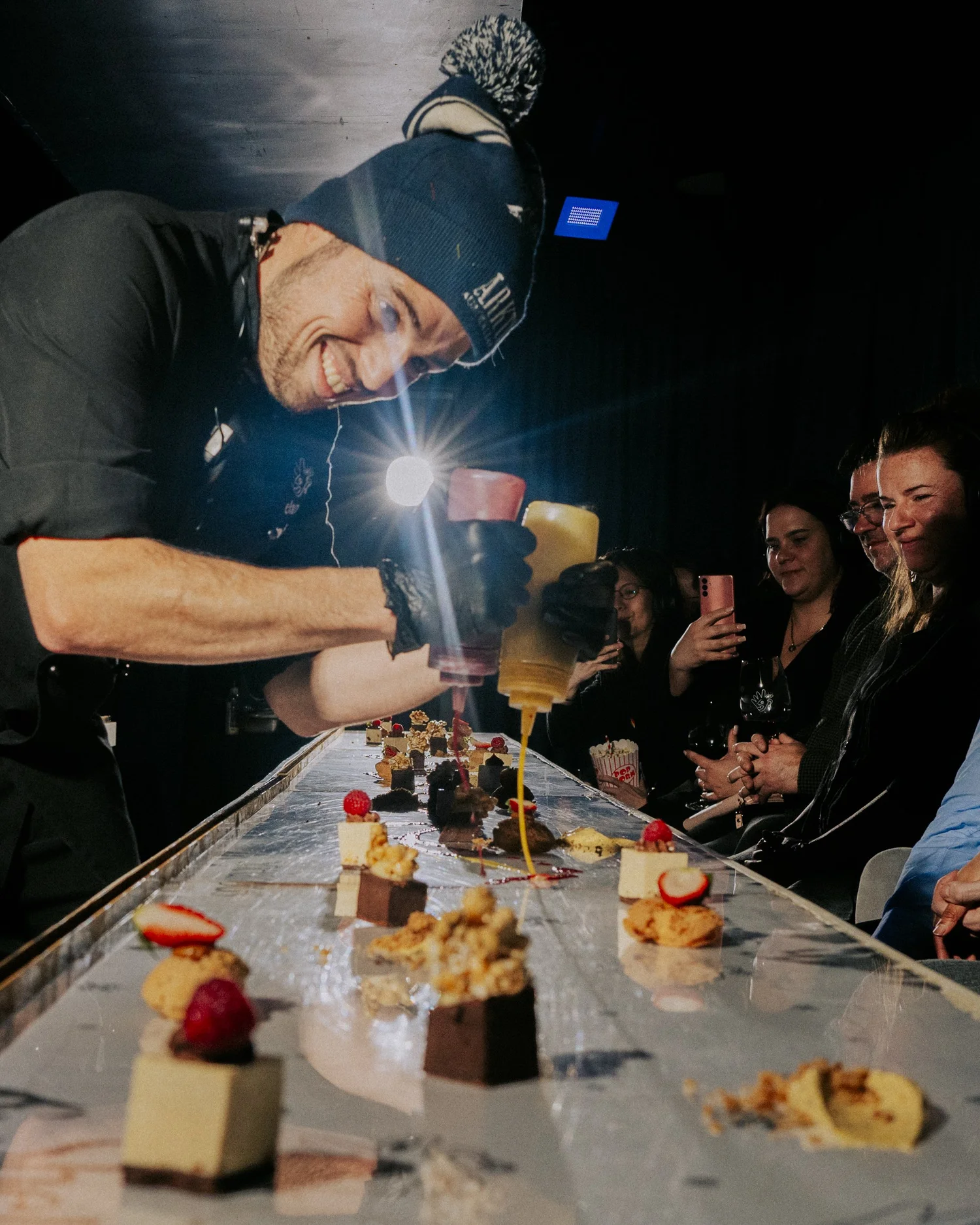 Shelanous restaurant chef plating dessert at the long table